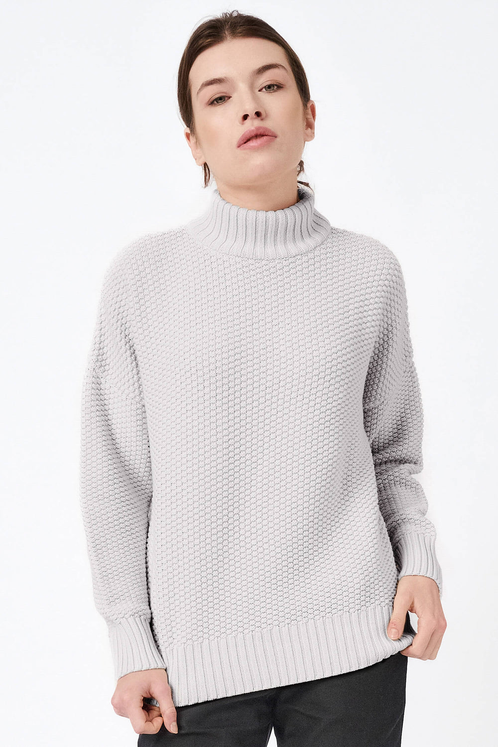 Knitted organic cotton high neck pullover in grey, featuring a minimalist design with a soft, rice cubes knit texture for warmth and comfort.