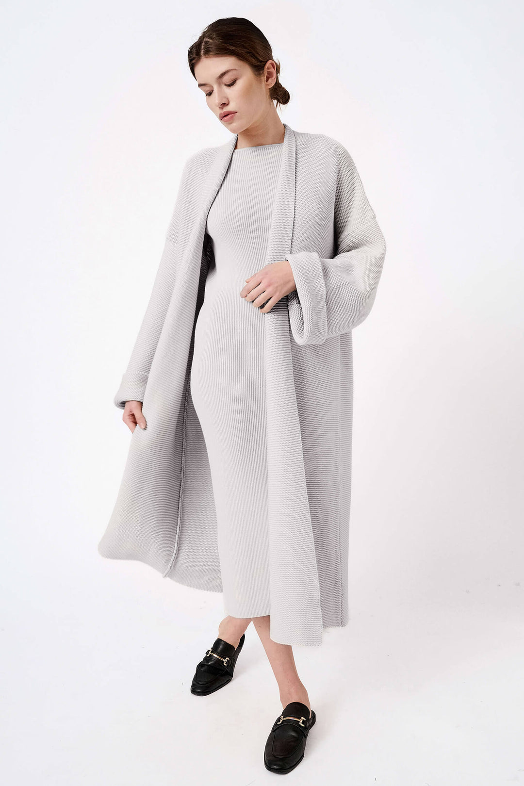 Organic cotton long cardigan coat in grey, designed with a chunky knit and minimalist silhouette, perfect for effortless, eco-friendly outerwear.